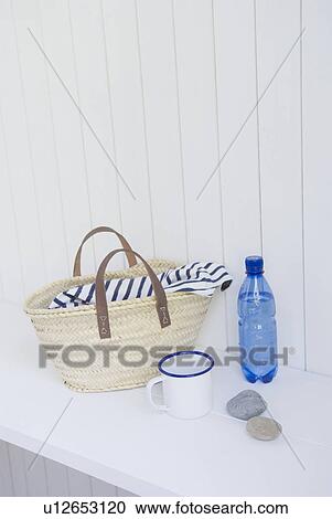 Stock Image - Straw bag and mineral water. Fotosearch