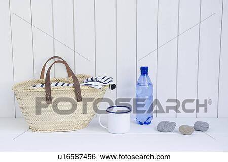 Straw bag and mineral water View Large Photo Image Stock Photograph - Straw bag and mineral water. Fotosearch