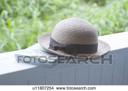 Picture - Straw hat and book. Fotosearch