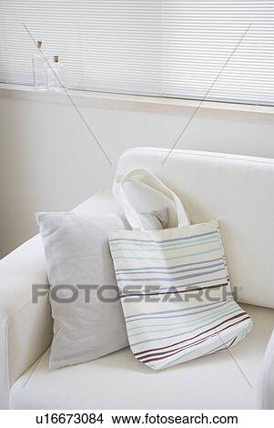 Picture - Striped bag on sofa. Fotosearch