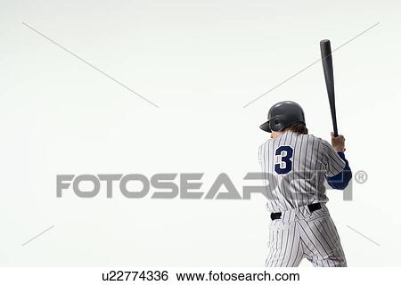 Stock Photograph - Baseball player standing with bat. Fotosearch