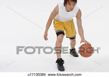 Basketball player bouncing ball View Large Photo Image Stock Photography - Basketball player bouncing ball. Fotosearch