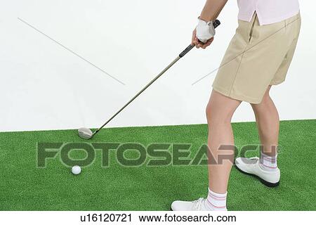 Female golfer preparing to hit golf ball View Large Photo Image Stock Image - Female golfer preparing to hit golf ball. Fotosearch