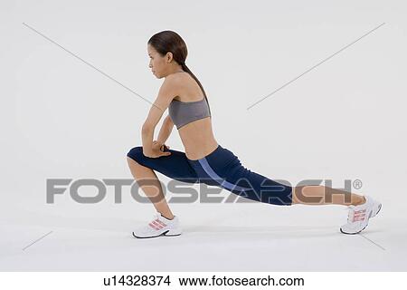 Female runner stretching View Large Photo Image Picture - Female runner stretching. Fotosearch
