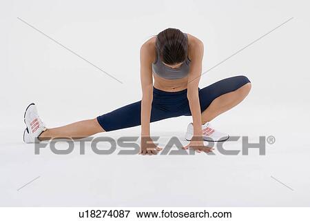 Female runner stretching View Large Photo Image Stock Photo - Female runner stretching. Fotosearch