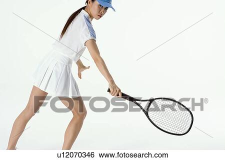 Female tennis player preparing to hit ball View Large Photo Image Stock Photograph - Female tennis player preparing to hit ball. Fotosearch
