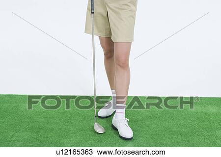 Stock Image - Legs of female golfer. Fotosearch