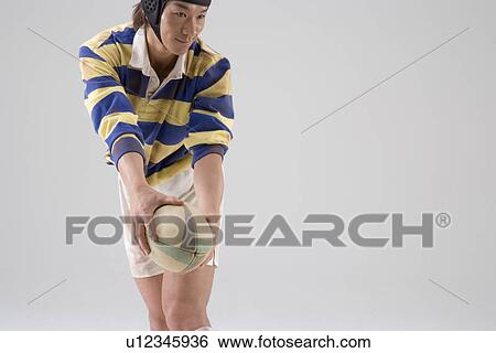 Rugby player trying to throw ball View Large Photo Image Stock Photograph - Rugby player trying to throw ball. Fotosearch