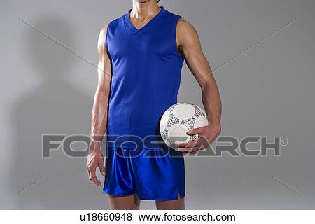 Soccer player holding ball View Large Photo Image Stock Photo - Soccer player holding ball. Fotosearch