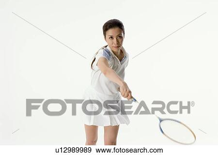 Young woman playing badminton View Large Photo Image Stock Photo - Young woman playing badminton. Fotosearch