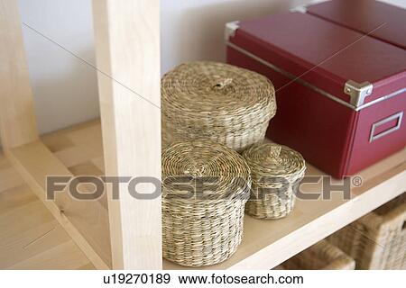 Stock Photo - Baskets and boxes on shelf. Fotosearch
