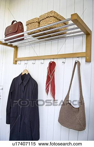 Stock Photography - Coat and bag on hangers. Fotosearch