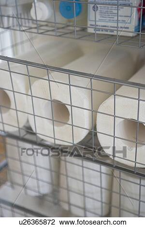 Stock Image - Toilet papers in wire rack. Fotosearch