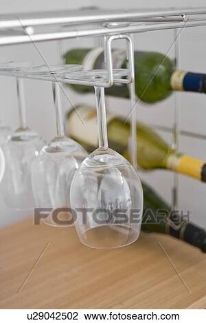 Stock Image - Wineglasses hanging. Fotosearch
