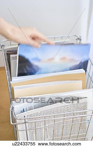 Woman picking book from wire basket View Large Photo Image Stock Photography - Woman picking book from wire basket. Fotosearch