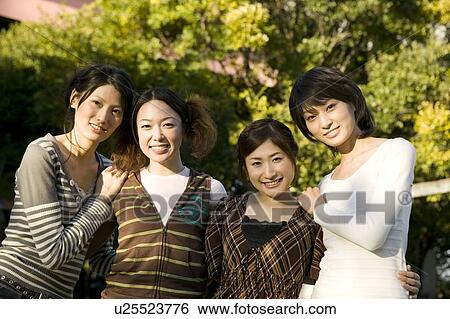 Stock Photograph - Portrait of four women smiling. Fotosearch