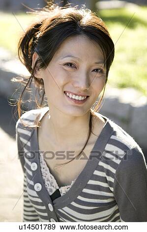 Stock Photo - Portrait of mid adult woman smiling. Fotosearch
