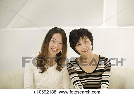 Stock Photo - Portrait of two young women smiling. Fotosearch