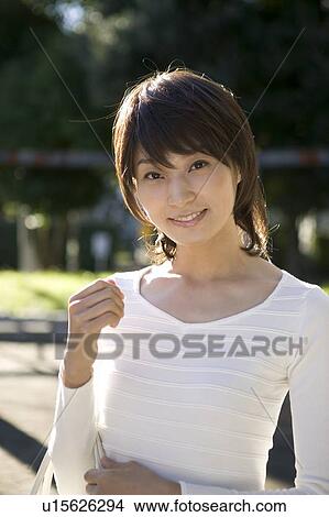 Portrait of young woman smiling View Large Photo Image Picture - Portrait of young woman smiling. Fotosearch