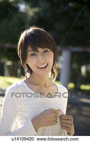 Stock Image - Portrait of young woman smiling. Fotosearch