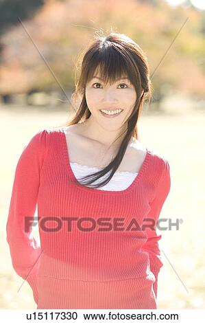 Stock Image - Portrait of young woman smiling. Fotosearch