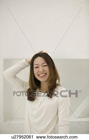 Stock Image - Portrait of young woman smiling. Fotosearch