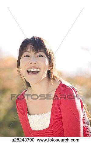 Stock Image - Portrait of young woman smiling. Fotosearch