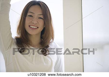 Portrait of young woman smiling View Large Photo Image Stock Photo - Portrait of young woman smiling. Fotosearch