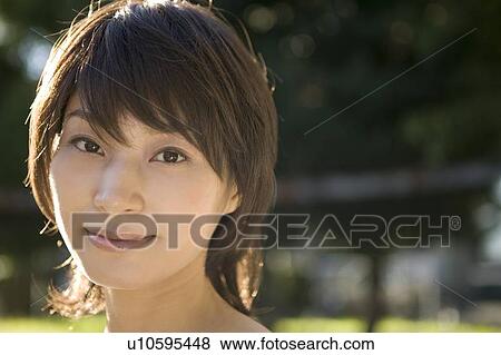 Stock Photo - Portrait of young woman smiling. Fotosearch