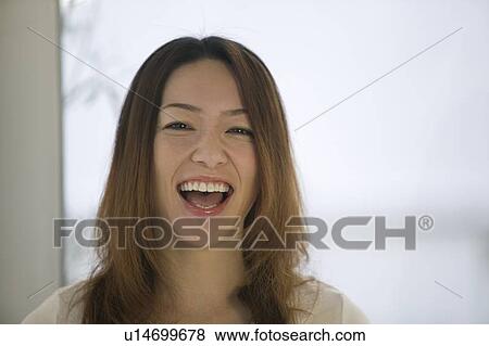Stock Photo - Portrait of young woman smiling. Fotosearch