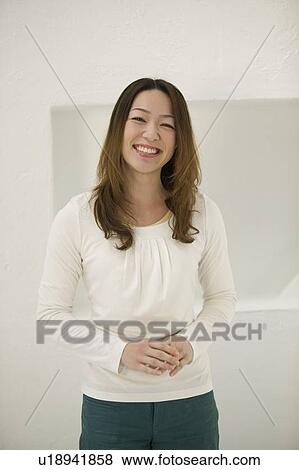 Stock Photo - Portrait of young woman smiling. Fotosearch