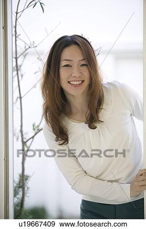 Stock Photo - Portrait of young woman smiling. Fotosearch