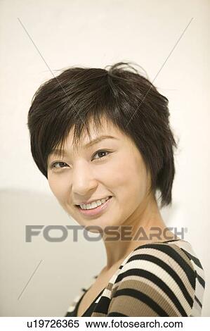 Stock Photography - Portrait of young woman smiling. Fotosearch