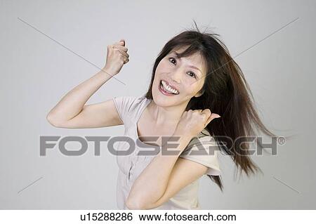 Stock Photograph - Young woman clutching fists. Fotosearch
