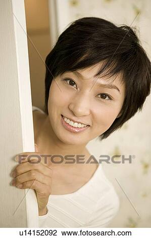 Young woman opening door View Large Photo Image Stock Image - Young woman opening door. Fotosearch