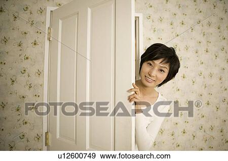 Young woman opening door View Large Photo Image Stock Photo - Young woman opening door. Fotosearch