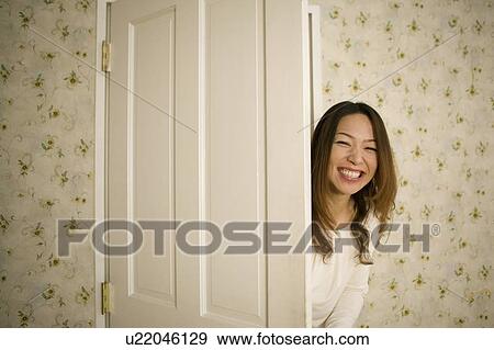 Young woman opening door View Large Photo Image Stock Photo - Young woman opening door. Fotosearch