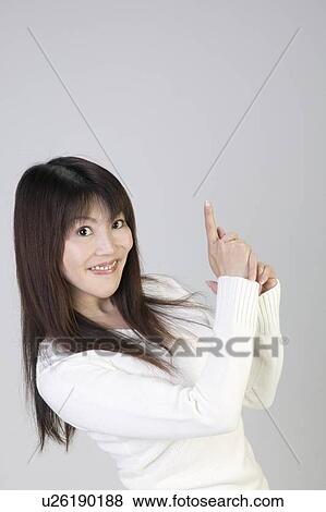 Young woman pointing her fingers like pistol View Large Photo Image Stock Photo - Young woman pointing her fingers like pistol. Fotosearch