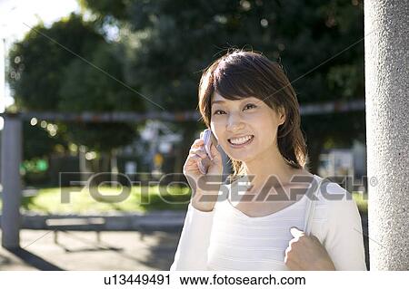 Young woman using mobile phone View Large Photo Image Stock Image - Young woman using mobile phone. Fotosearch