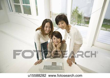 Young women using computer View Large Photo Image Stock Image - Young women using computer. Fotosearch