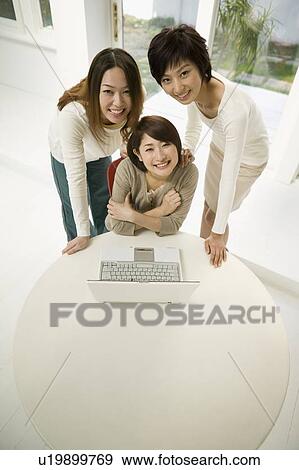 Young women using computer View Large Photo Image Stock Photo - Young women using computer. Fotosearch