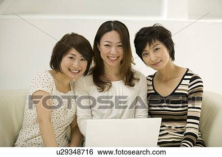 Stock Photograph - Young women using computer. Fotosearch