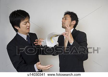 Stock Image - Businessman tearing document. Fotosearch