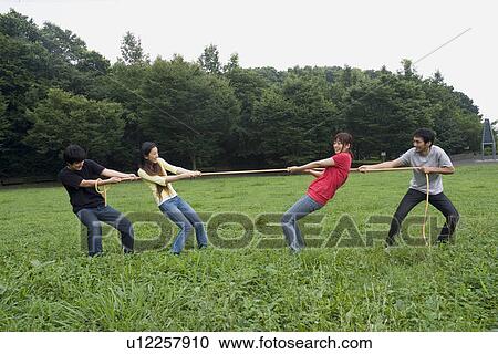 Stock Image - Four people pulling rope. Fotosearch