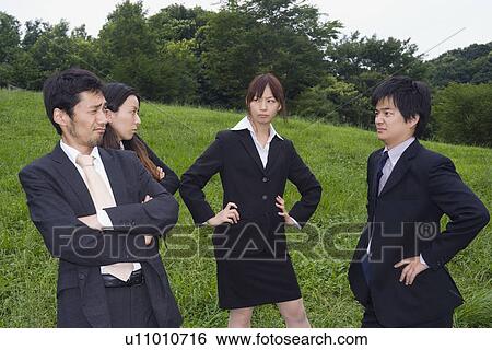 Four young people standing View Large Photo Image Stock Photograph - Four young people standing. Fotosearch