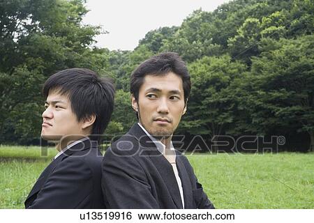 Stock Photograph - Portrait of two businessmen standing. Fotosearch