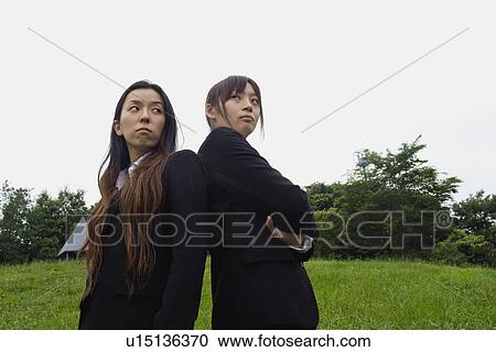 Stock Image - Portrait of two businesswomen standing. Fotosearch
