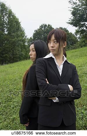 Stock Photograph - Portrait of two businesswomen standing. Fotosearch