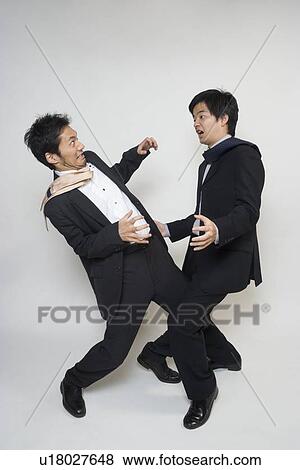 Two businessmen fighting View Large Photo Image Stock Photo - Two businessmen fighting. Fotosearch