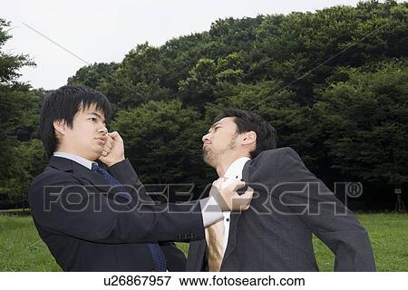Stock Photo - Two businessmen fighting. Fotosearch